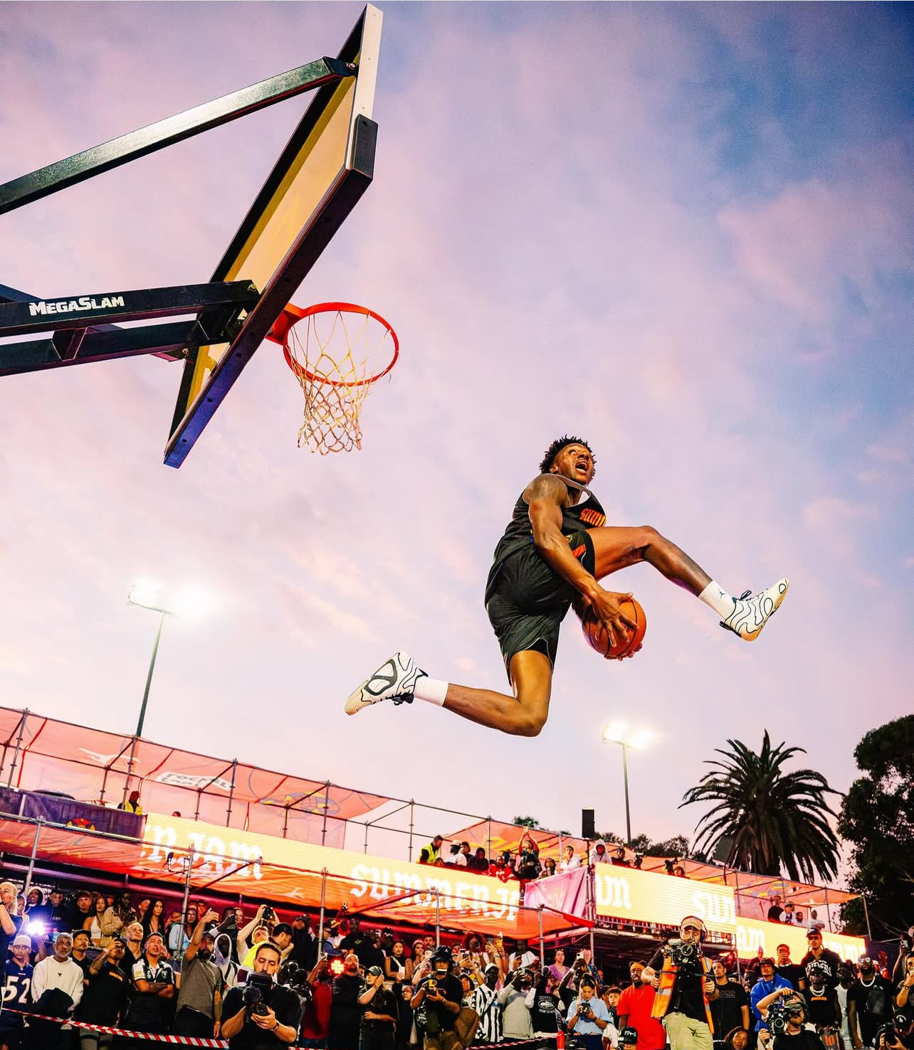 The Royal Guard soaring above the rim at Summer Jam under a purple sunset sky