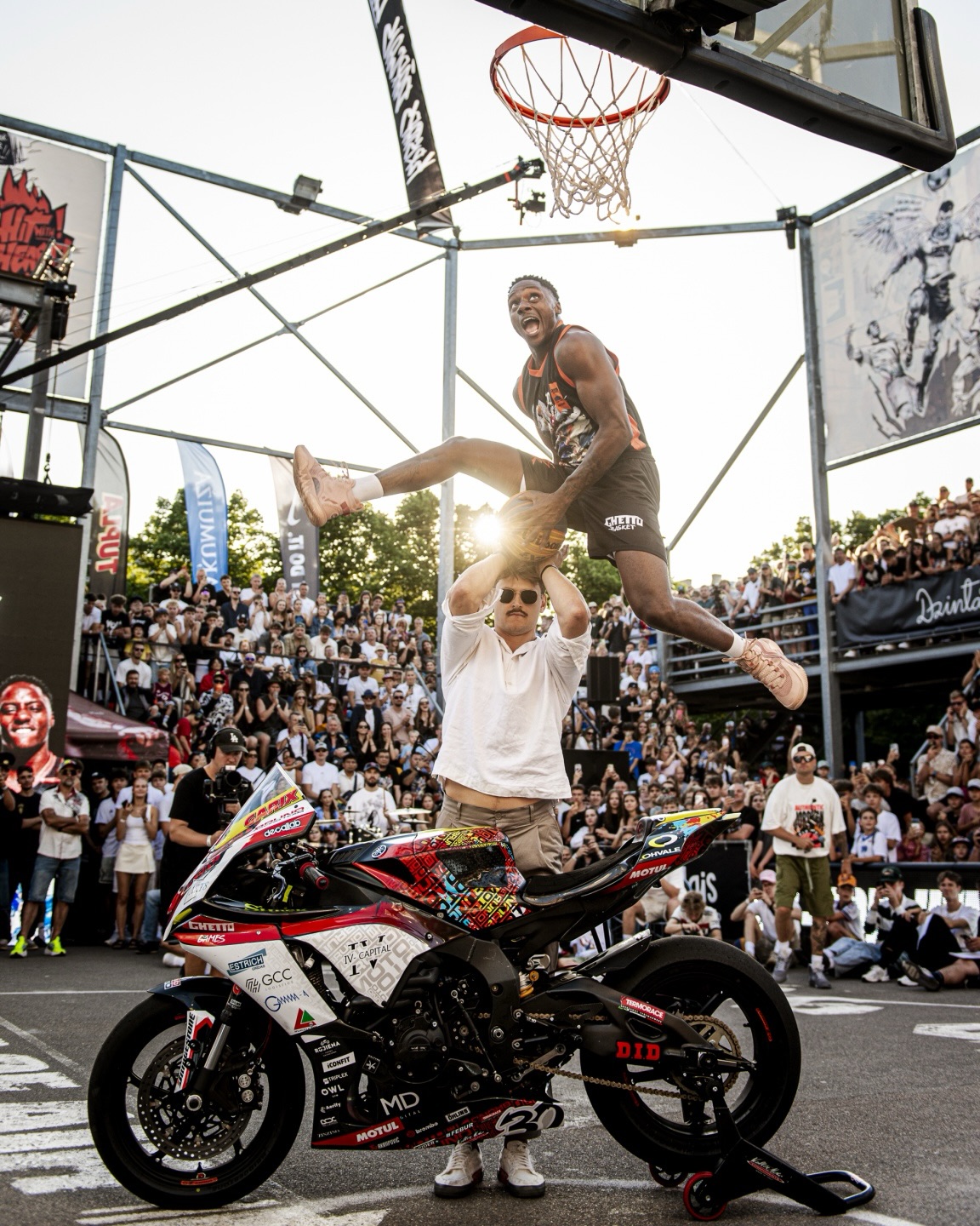 The Royal Guard leaping over a motorbike and rider to finish a dunk
